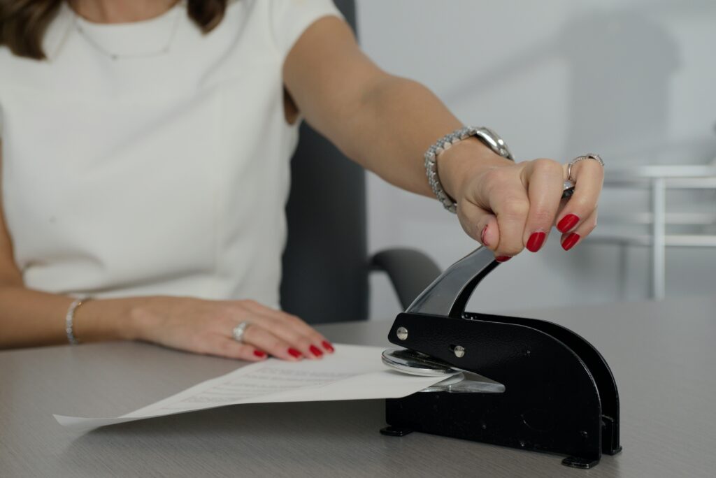 female-notary-close-up-stamping-seal-on-official-document